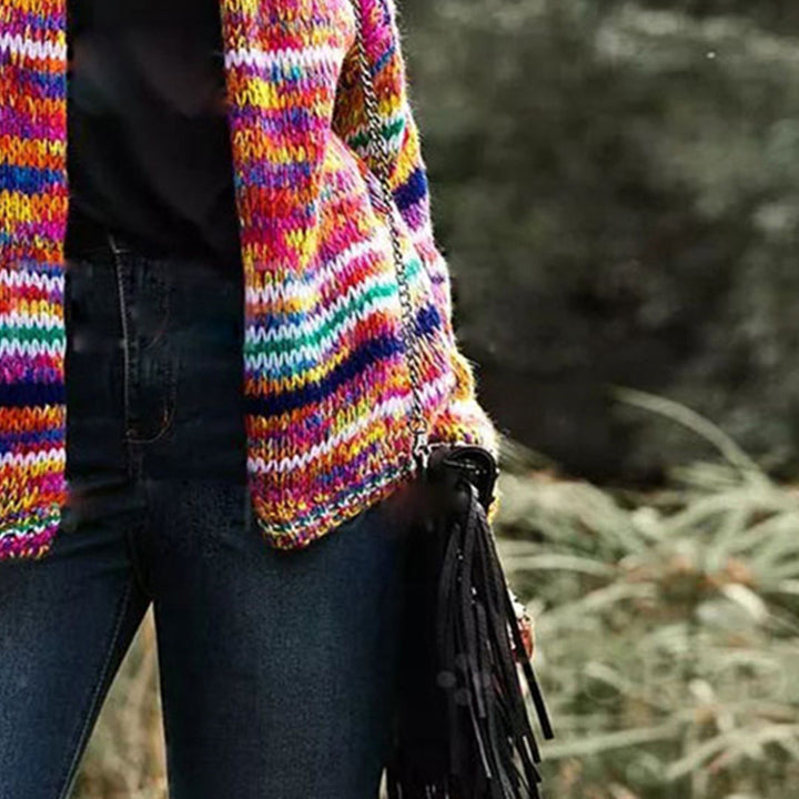Woman in chunky rainbow striped knit cardigan