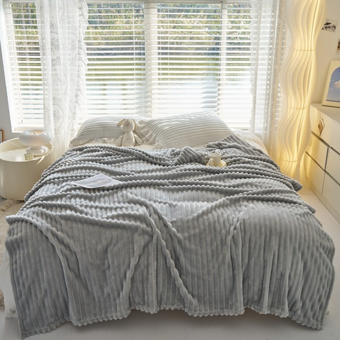 Dusty rose ribbed faux fur blanket on bed