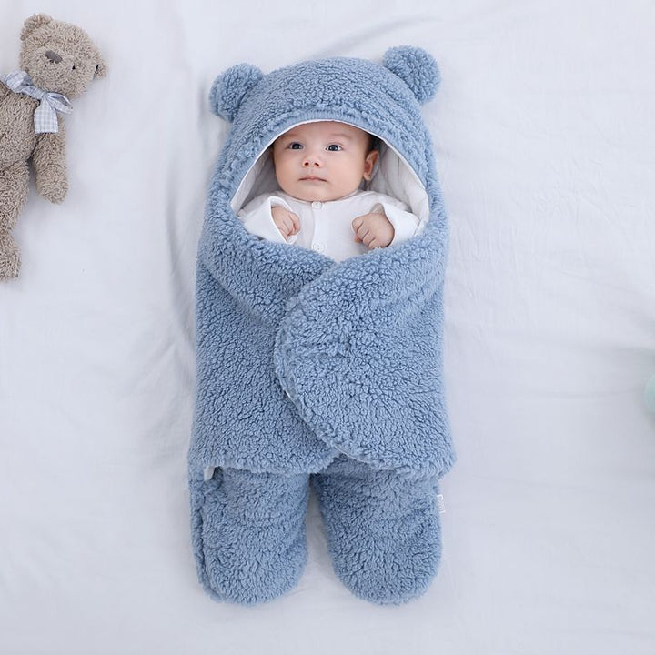 Baby in plush bear-ear hooded wrap