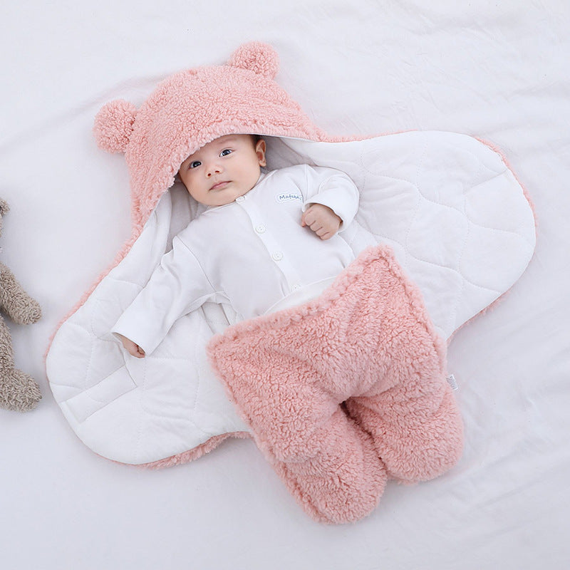 Baby in plush bear-ear hooded wrap