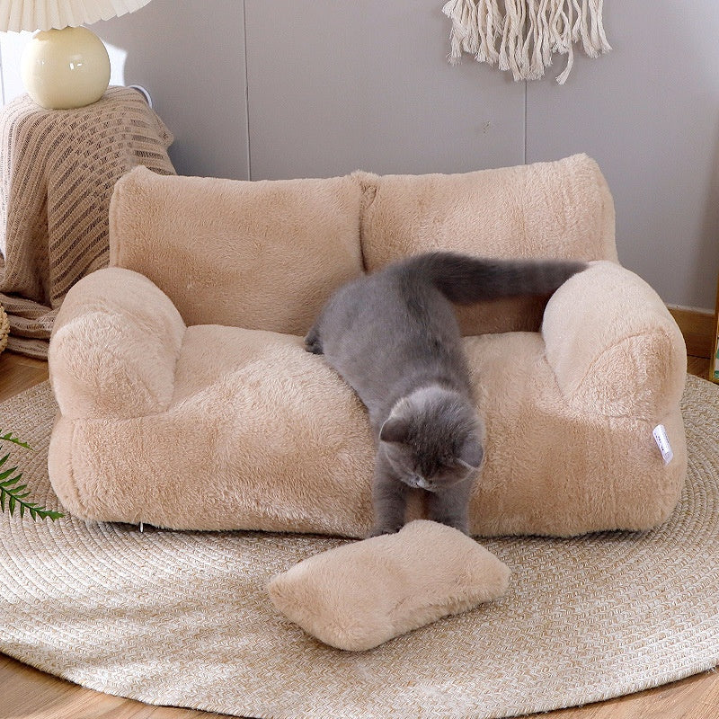 Cat lying on plush pet sofa with pillow