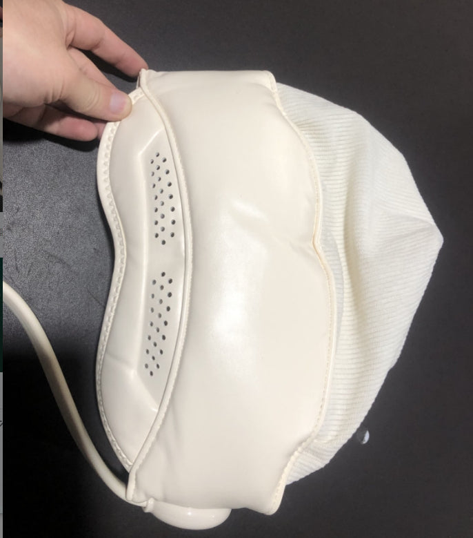Person wearing hooded head massager wrap