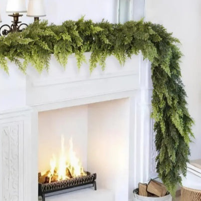 Green Norfolk pine garland on a mantelpiece