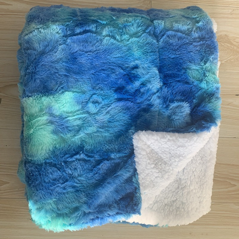 Thick sherpa blanket folded on a sofa