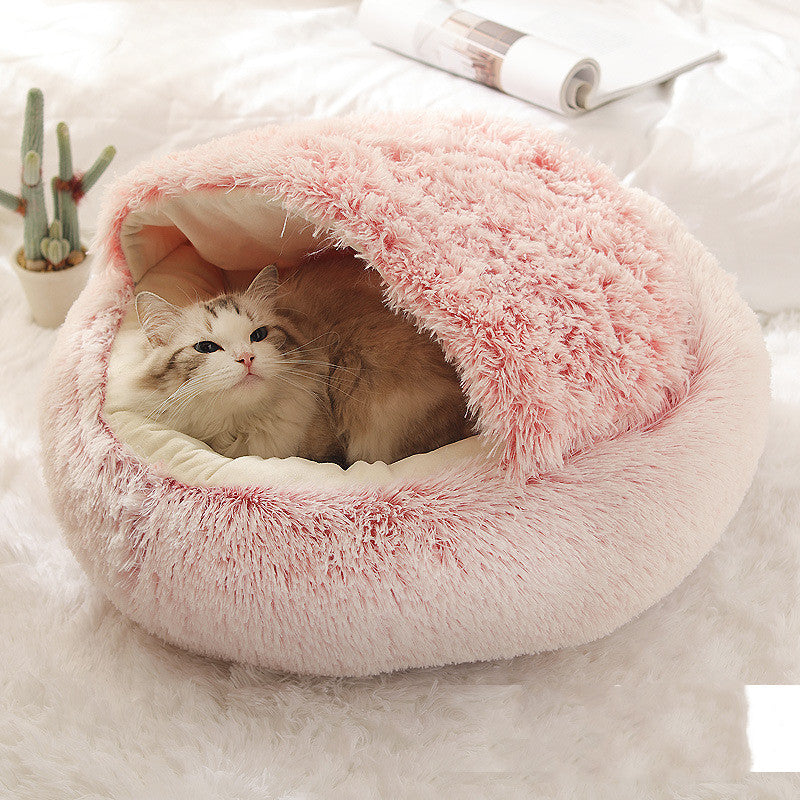 Cat curled in round plush hooded pet bed
