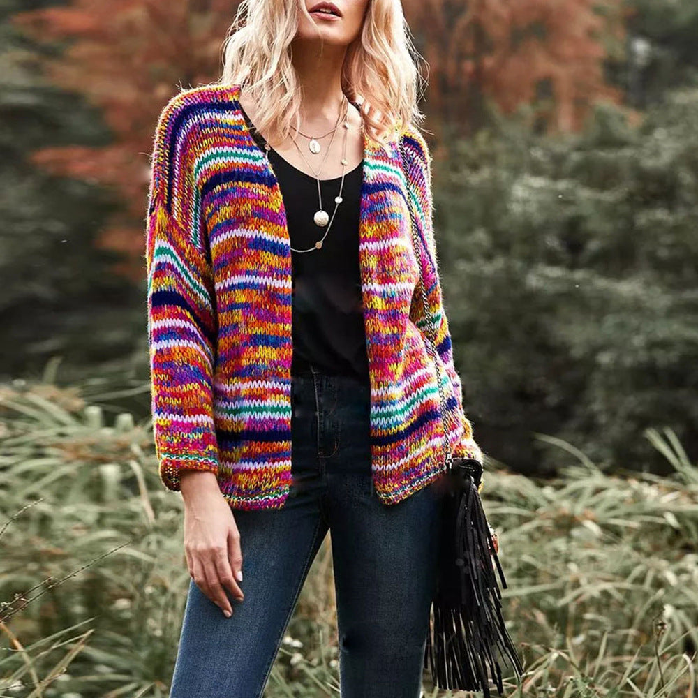 Woman in chunky rainbow striped knit cardigan