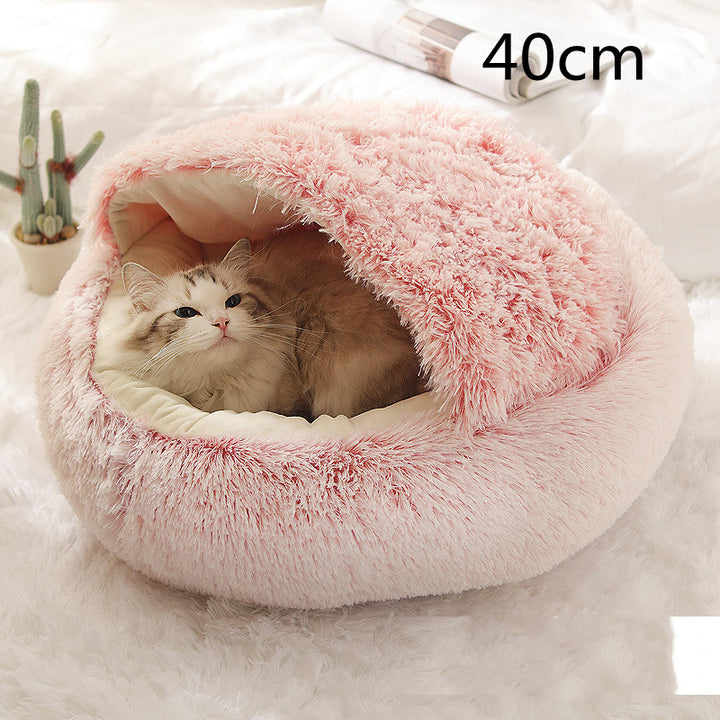 Cat curled in round plush hooded pet bed