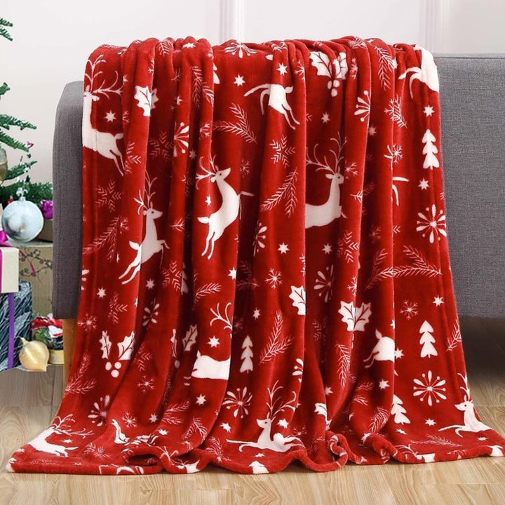Christmas fleece throw blanket on a sofa