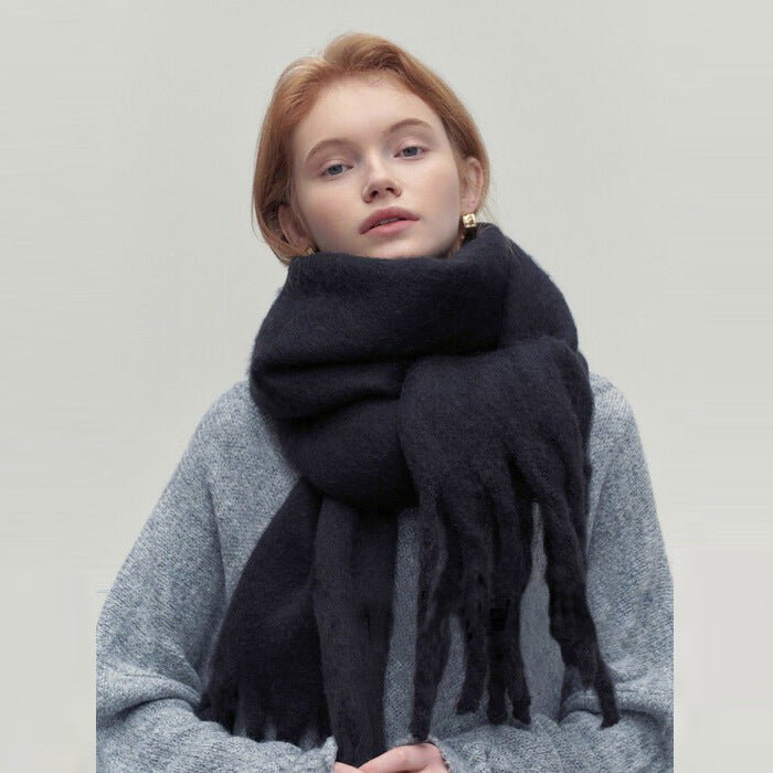 Woman wearing long ivory scarf with tassels