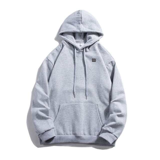 Man in a black heated pullover hoodie
