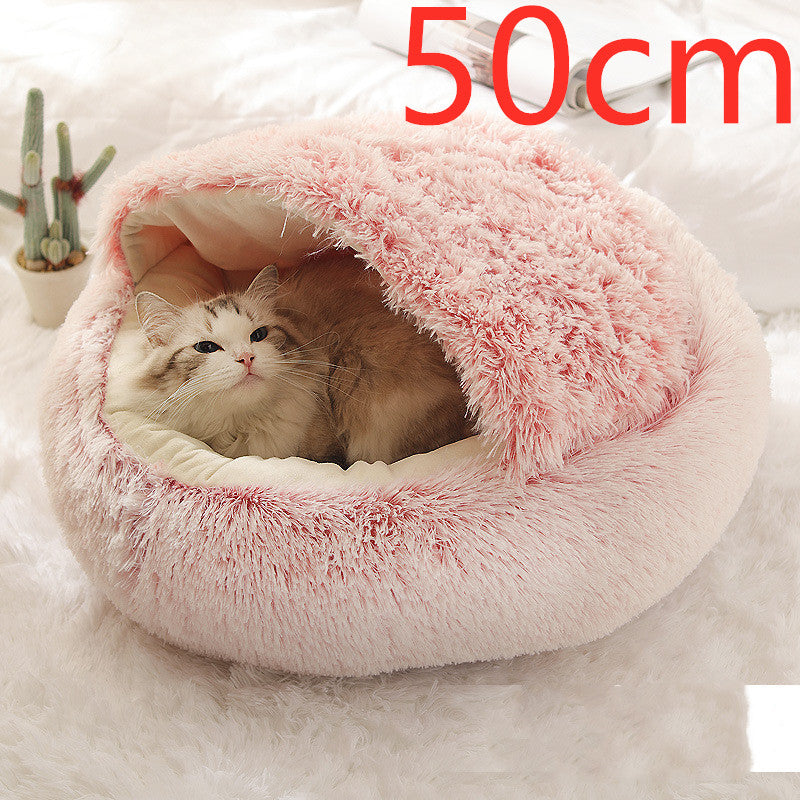 Cat curled in round plush hooded pet bed