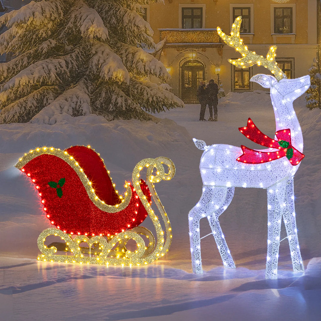 Lit reindeer and sleigh on front lawn