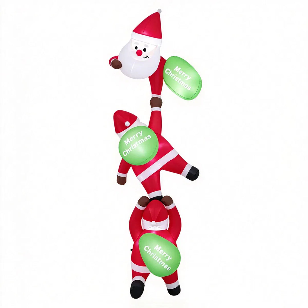 Three inflatable Santas climbing