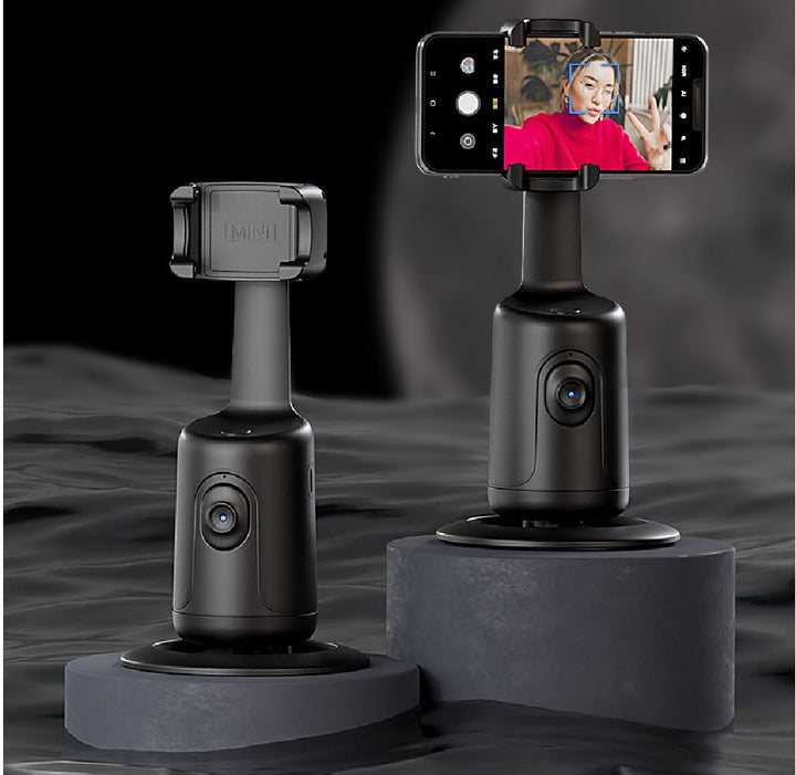Face-tracking phone holder rotating with phone