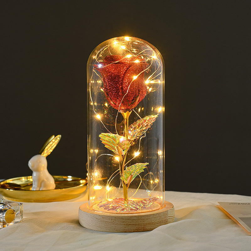 Preserved red rose in lit glass dome