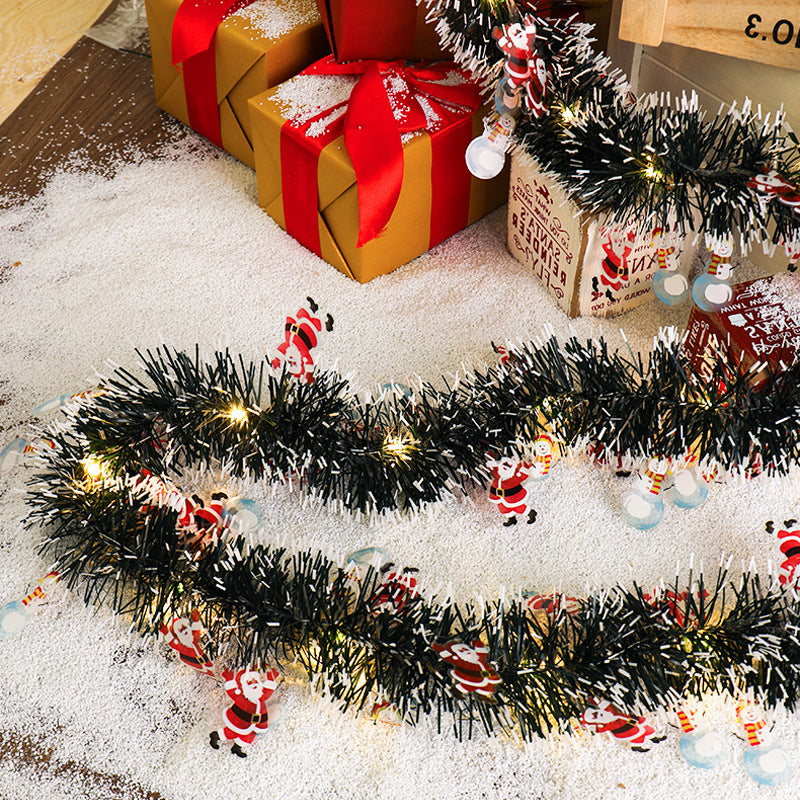 Tinsel Christmas garland with lights and Santas