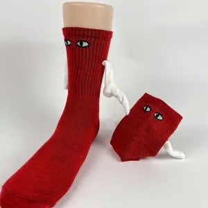 Two socks with magnetic hands holding each other