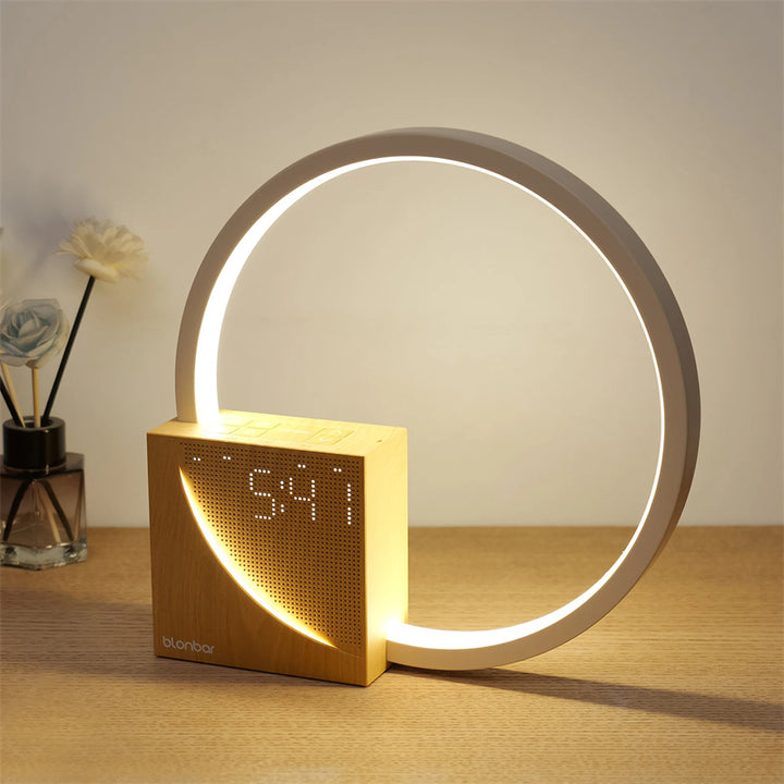 Ring lamp alarm clock glowing on bedside