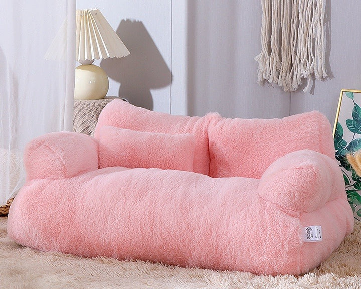 Cat lying on plush pet sofa with pillow
