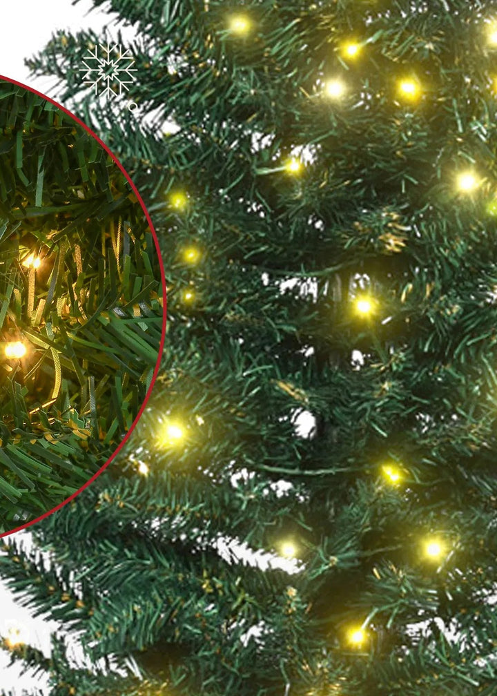 Tall slim green pencil tree with warm lights