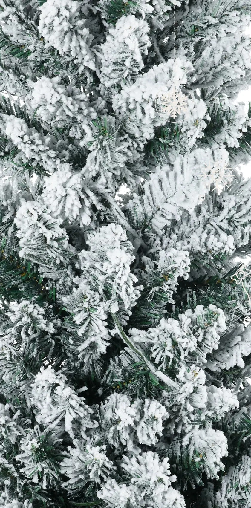 Slim white-flocked pencil tree with warm lights