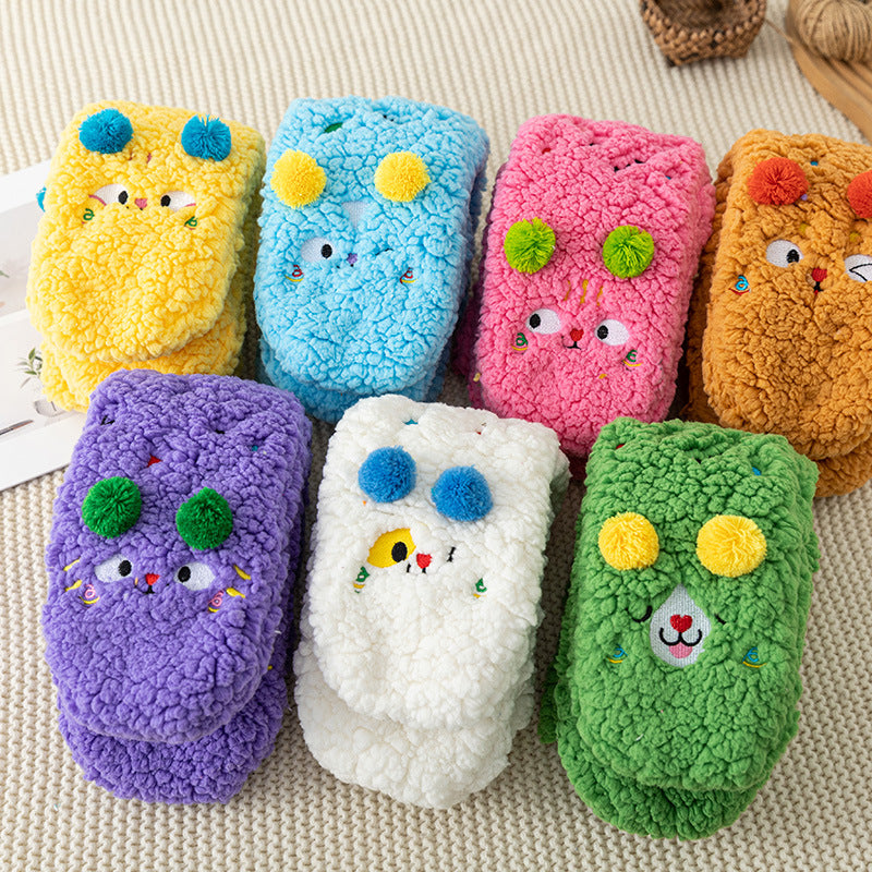 Fluffy yellow socks with embroidered face and pompoms