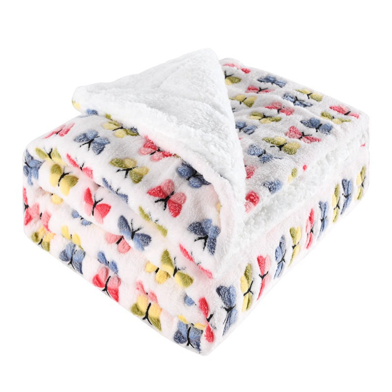 Thick sherpa blanket folded on a sofa