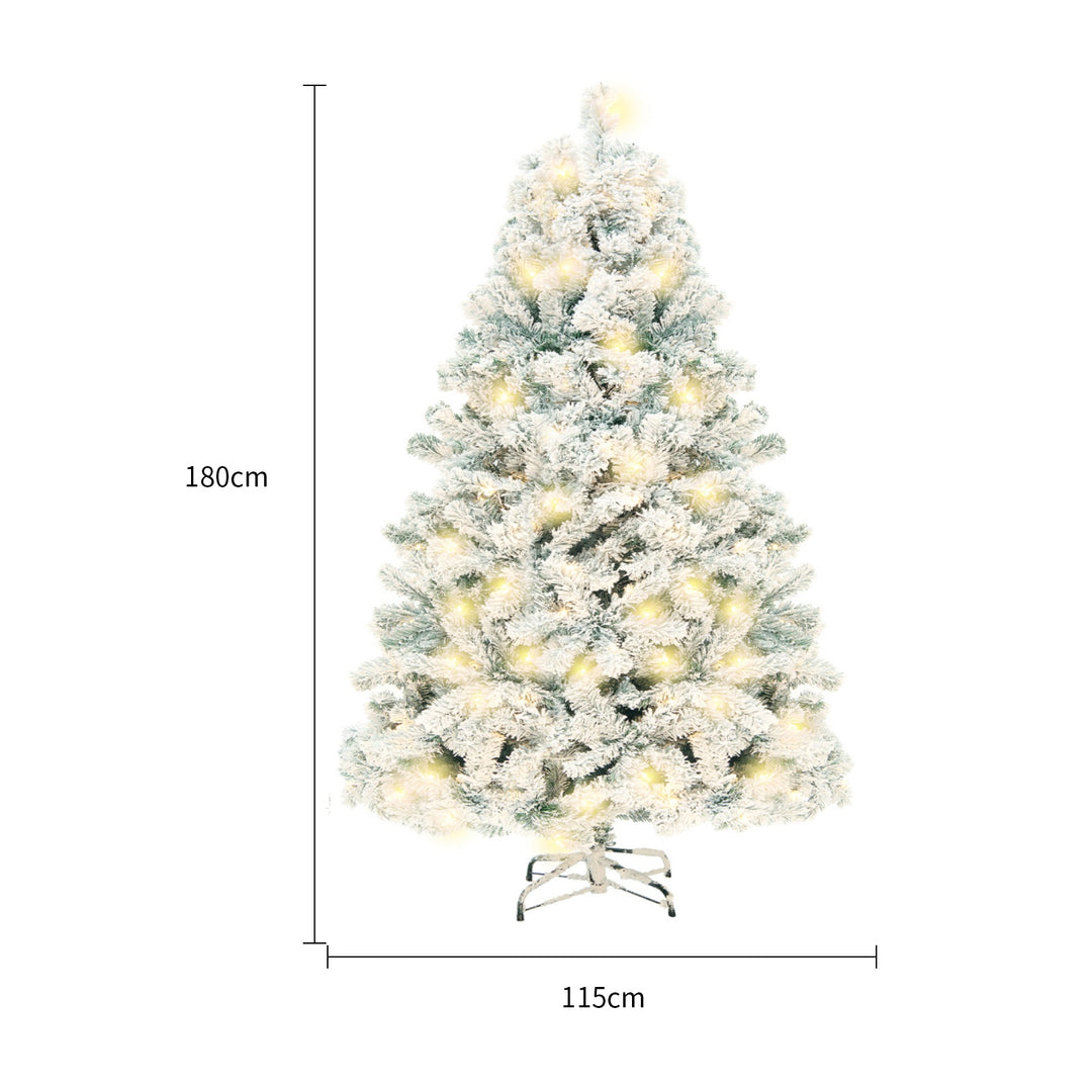 Snow-flocked Christmas tree with warm-white lights