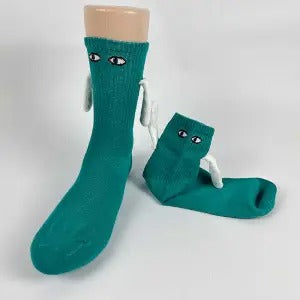 Two socks with magnetic hands holding each other
