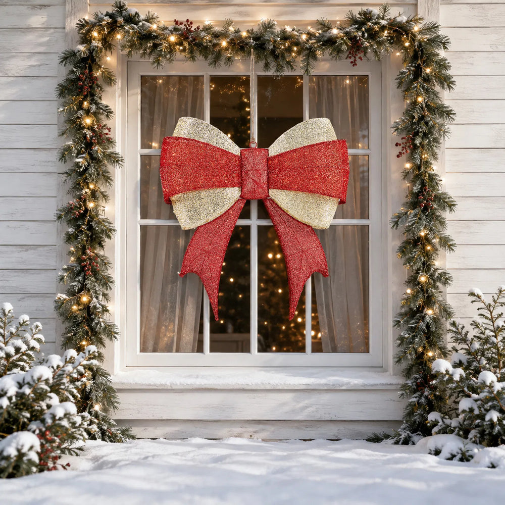 Large lit red and gold Christmas bow