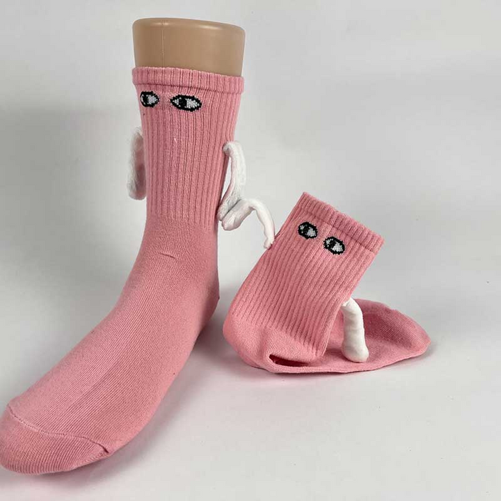 Two socks with magnetic hands holding each other