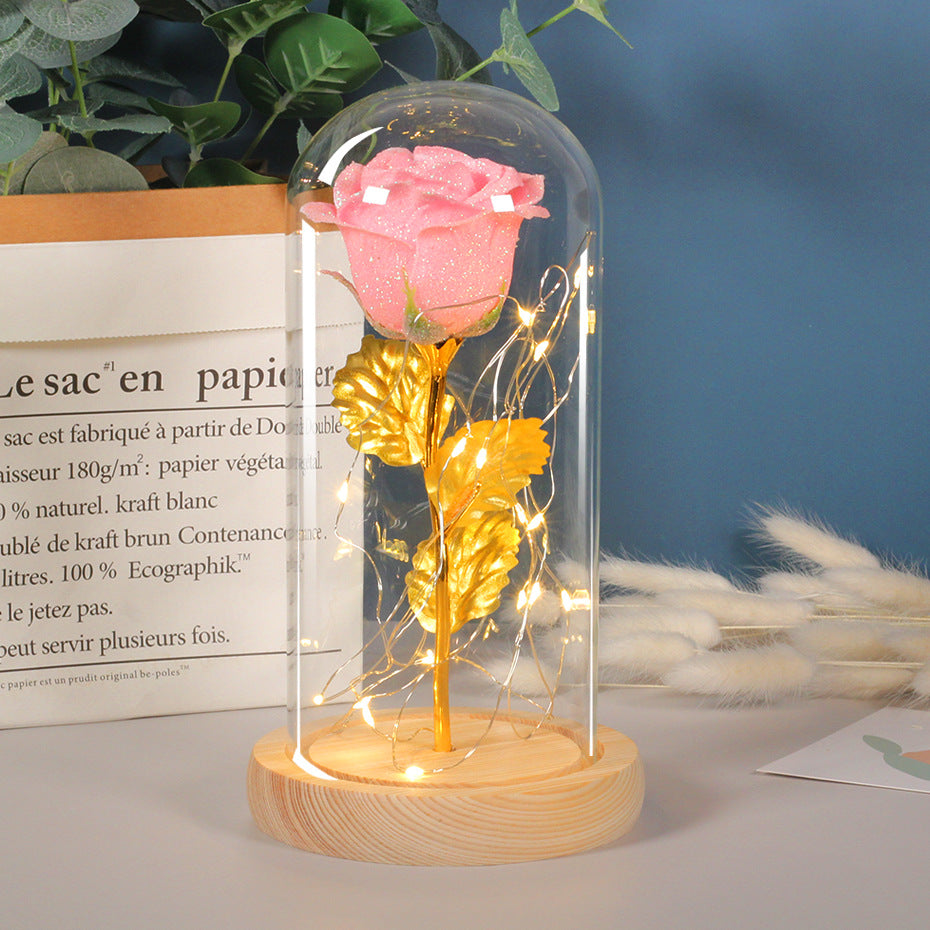 Preserved red rose in lit glass dome