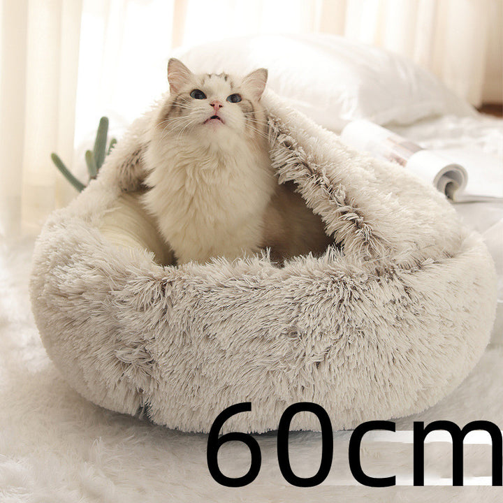 Cat curled in round plush hooded pet bed