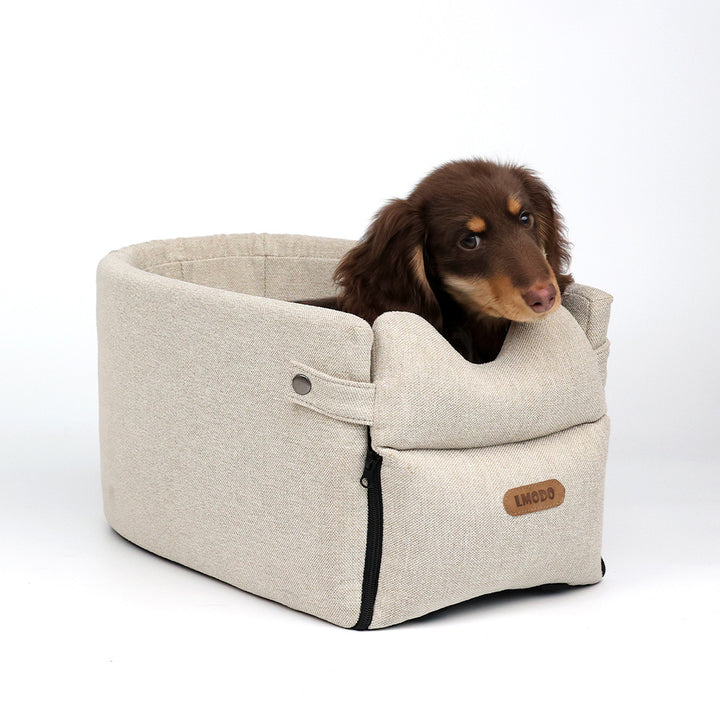Small dog in armrest car seat