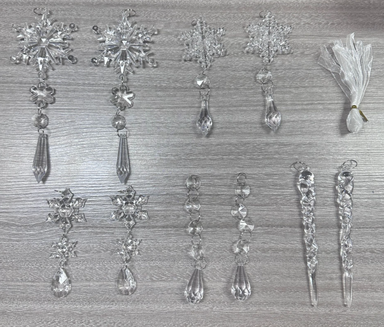 Clear acrylic icicle ornaments hanging on Christmas tree