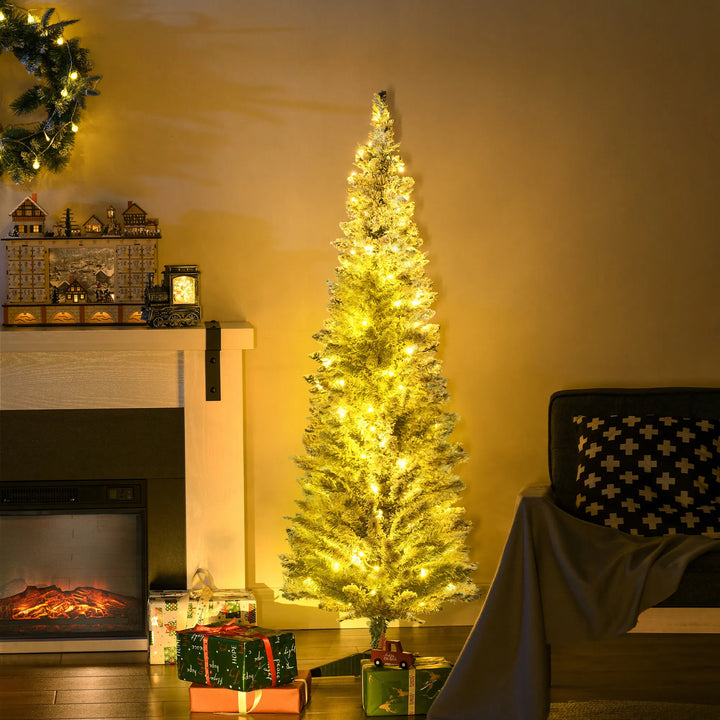 Snowy flocked pencil tree with warm lights