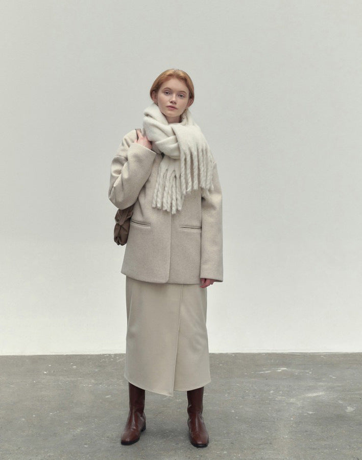 Woman wearing long ivory scarf with tassels