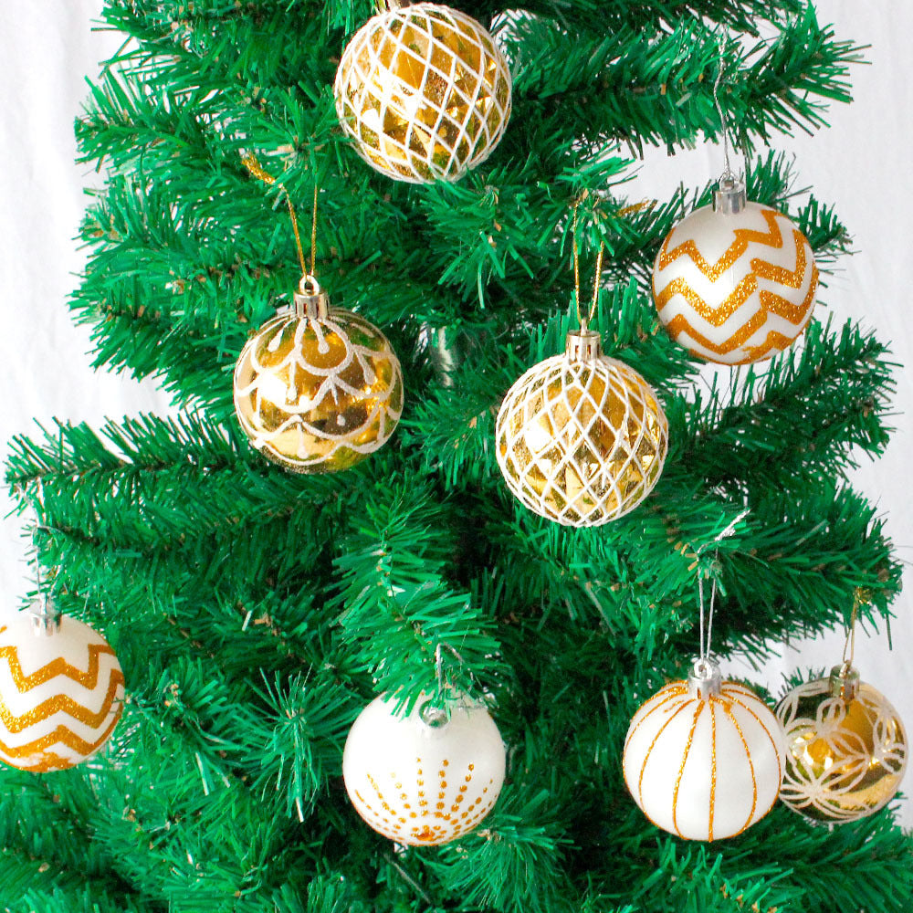 30 gold and white hand-painted Christmas baubles in a tub