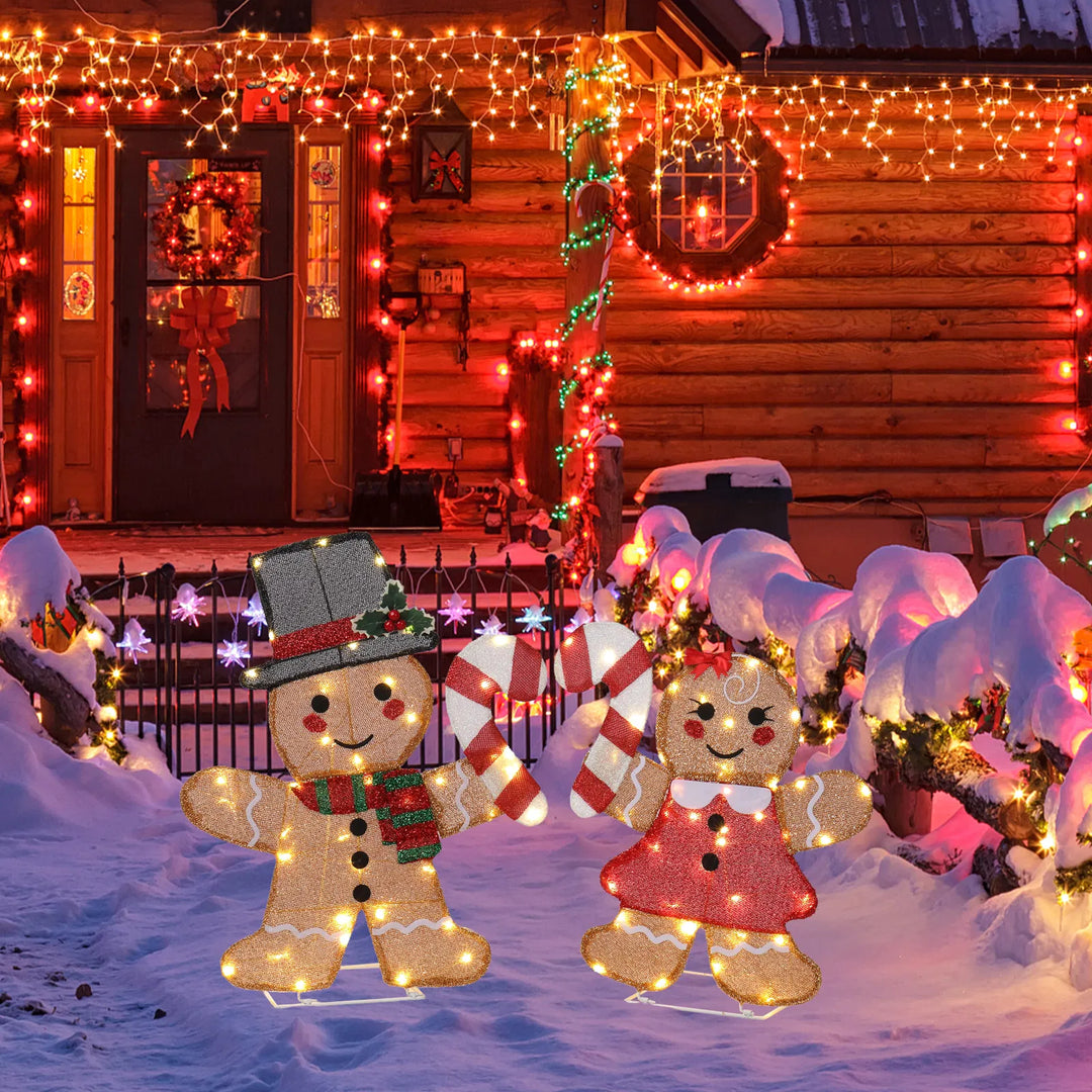 Two light-up gingerbread figures with candy canes