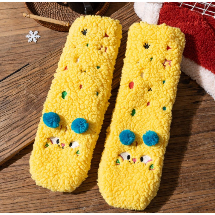 Fluffy yellow socks with embroidered face and pompoms