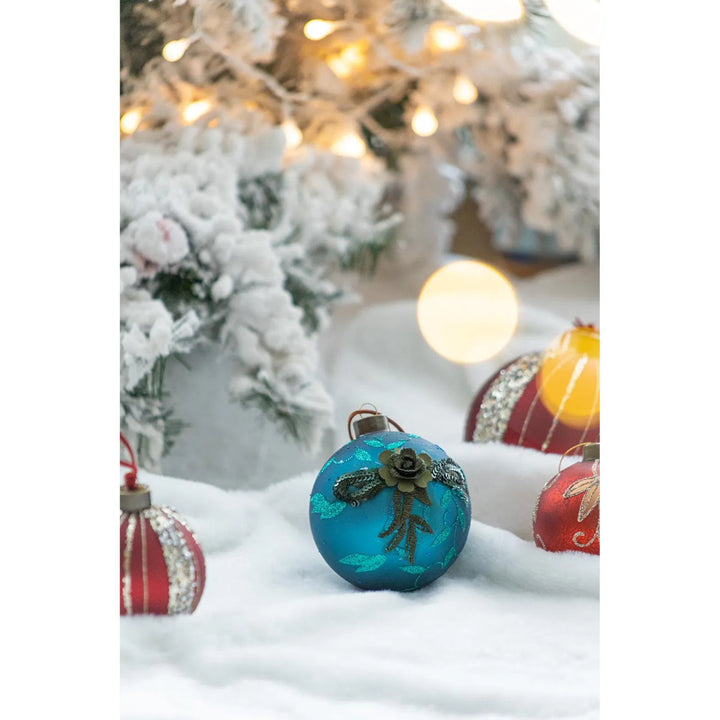 Four teal glass Christmas baubles with glitter