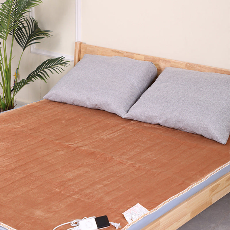 Brown flannel electric under blanket on bed